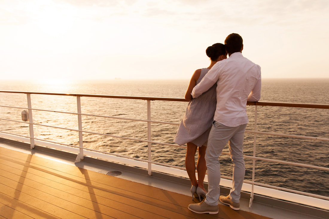 couple embracing on cruise ship during sunset